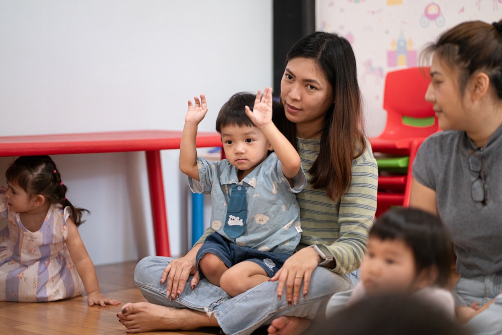 A teacher sitting with a young child in class