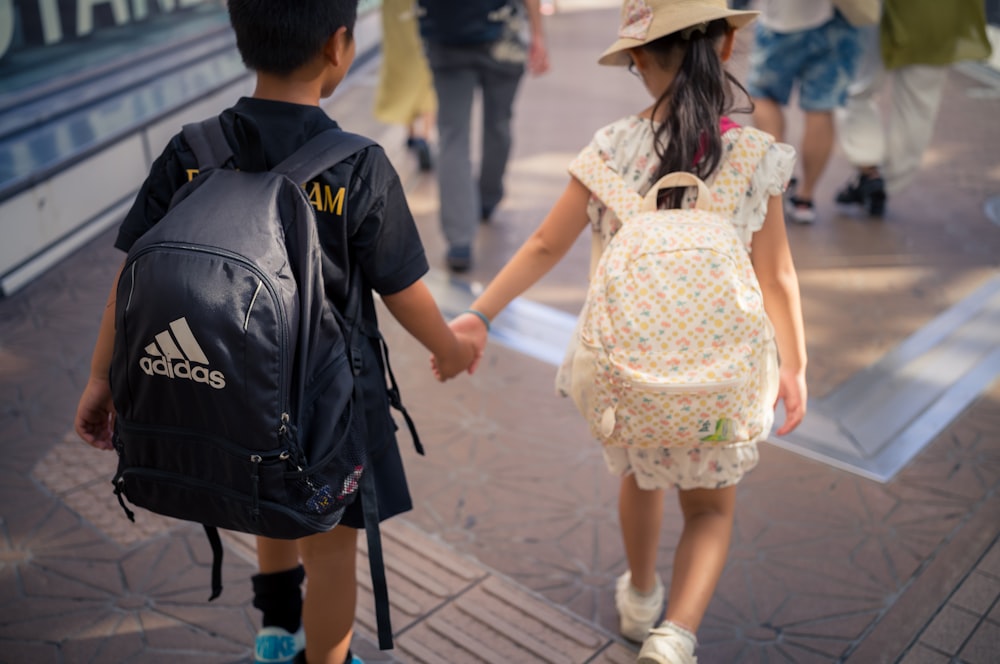 Two children walking together holding hands
